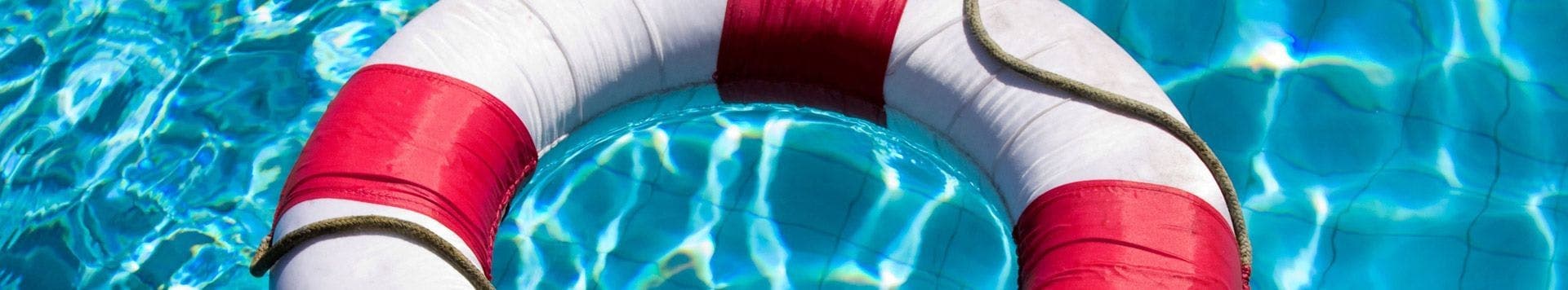 Life ring floating in a swimming pool, featured on personal injury solicitors banner